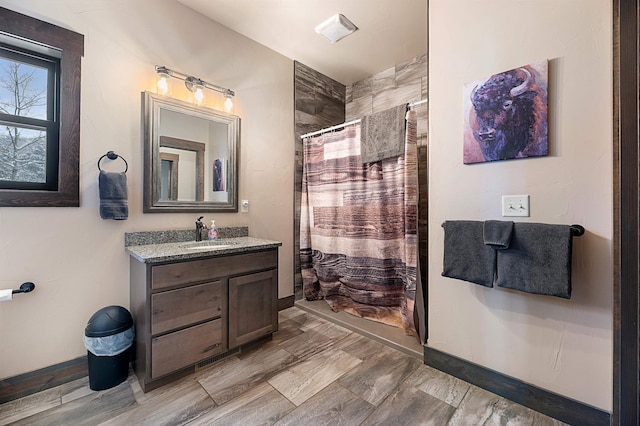 bathroom featuring vanity and curtained shower