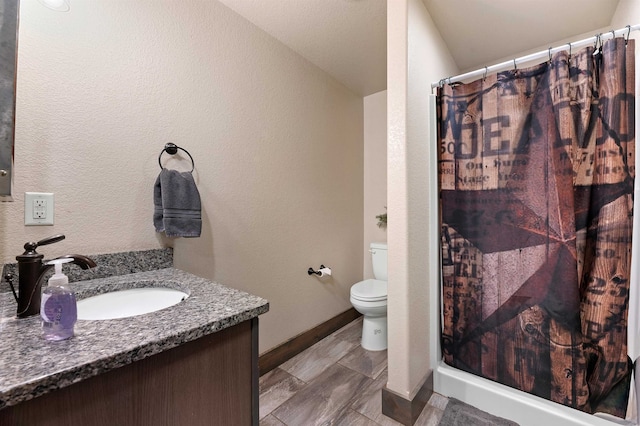 bathroom featuring a shower with curtain, vanity, lofted ceiling, and toilet