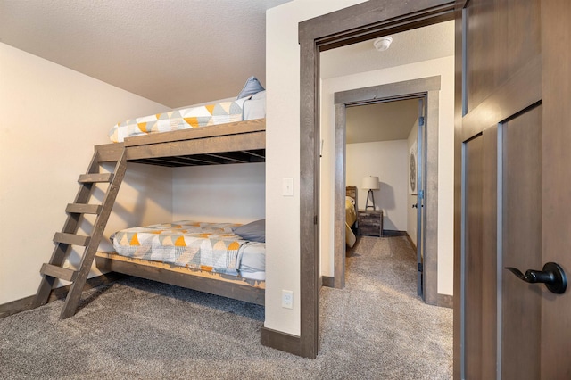 carpeted bedroom featuring a textured ceiling