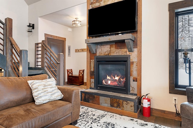 living room with a fireplace and wood-type flooring