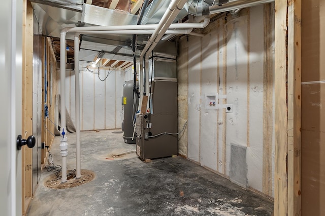 basement featuring heating unit and water heater