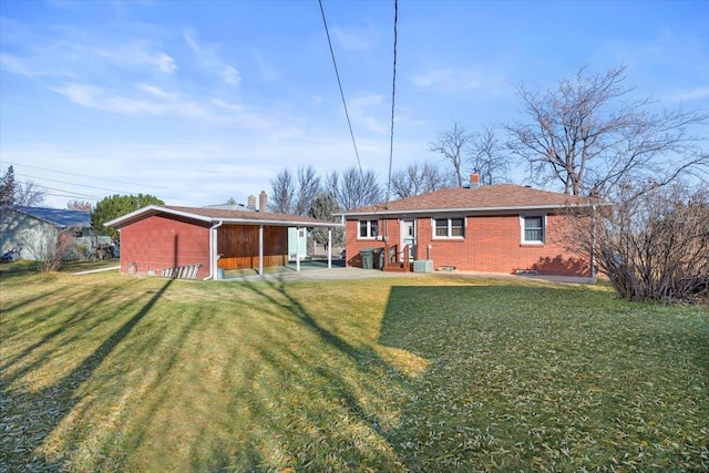 rear view of property with a yard and central AC unit