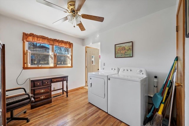 laundry area featuring ceiling fan, separate washer and dryer, and light hardwood / wood-style flooring