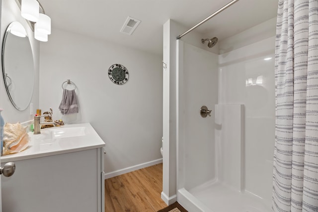 bathroom featuring hardwood / wood-style floors, a shower with curtain, and vanity