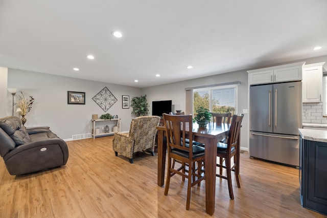 dining space featuring light wood-type flooring