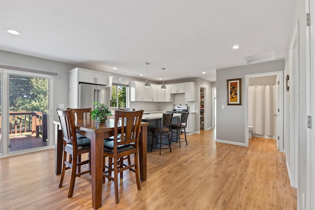 dining area featuring plenty of natural light and light wood-type flooring