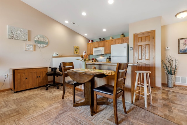 dining room with lofted ceiling