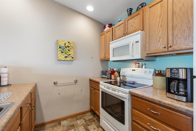 kitchen featuring white appliances and sink