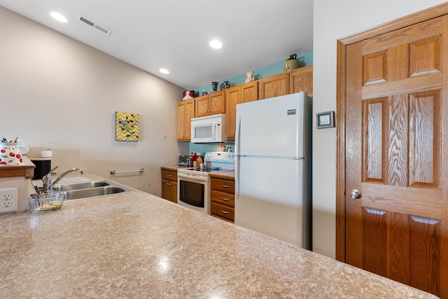 kitchen featuring sink and white appliances