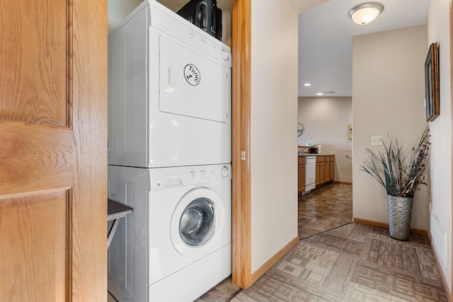 laundry area featuring stacked washer and clothes dryer