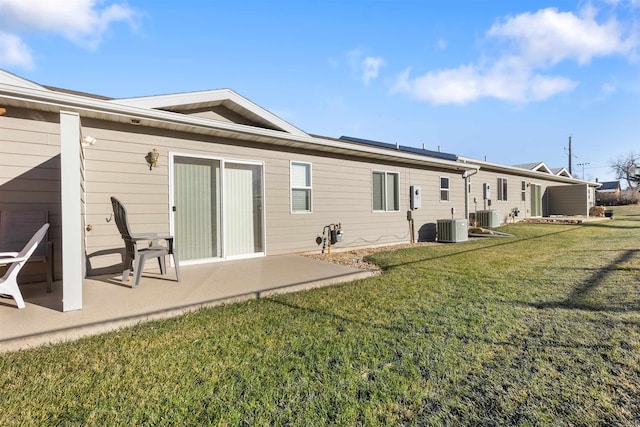 back of property featuring a patio area, a yard, and central AC unit