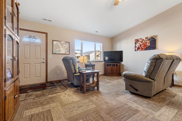 living room with ceiling fan, light carpet, and vaulted ceiling