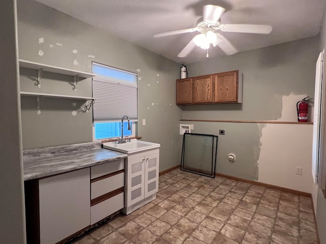 kitchen featuring ceiling fan and sink