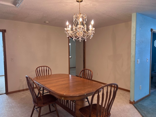 dining room featuring a textured ceiling and an inviting chandelier