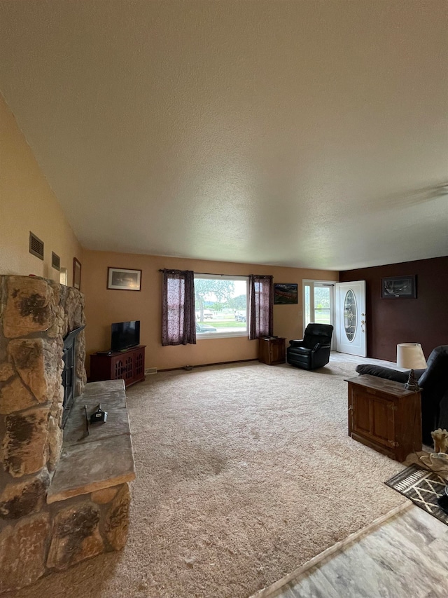 living room featuring carpet, a textured ceiling, and lofted ceiling