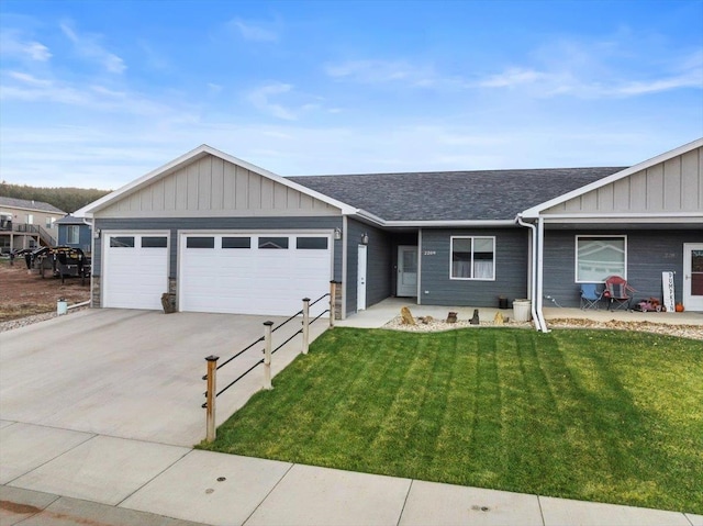 single story home featuring a garage and a front lawn