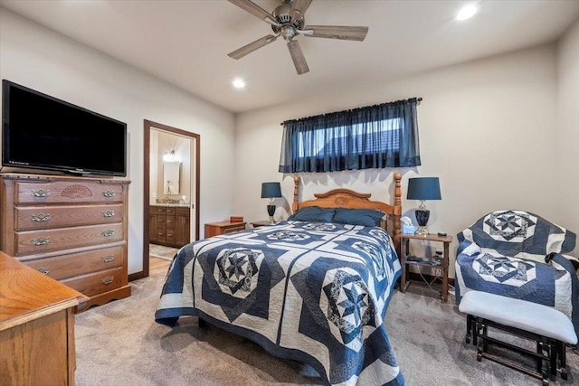 bedroom featuring carpet flooring, ensuite bath, and ceiling fan