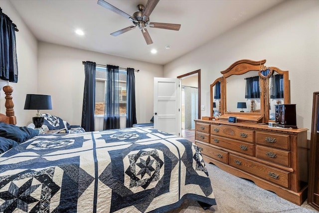 bedroom featuring carpet flooring, ensuite bath, and ceiling fan