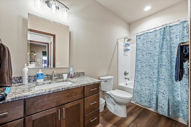 full bathroom featuring shower / bath combination with curtain, vanity, hardwood / wood-style flooring, and toilet