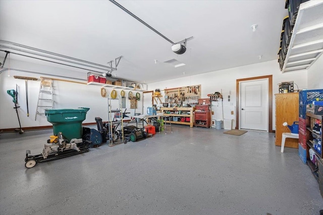 garage with a workshop area and a garage door opener