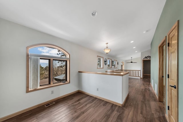 kitchen with pendant lighting, ceiling fan, and dark wood-type flooring