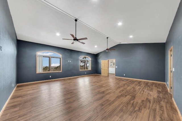 unfurnished living room featuring ceiling fan, wood-type flooring, and lofted ceiling