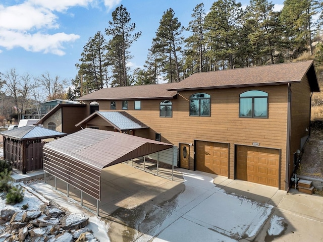 view of front of property featuring a carport and a garage