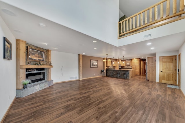 unfurnished living room with a premium fireplace and dark hardwood / wood-style floors