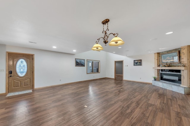 unfurnished living room featuring a fireplace and dark wood-type flooring