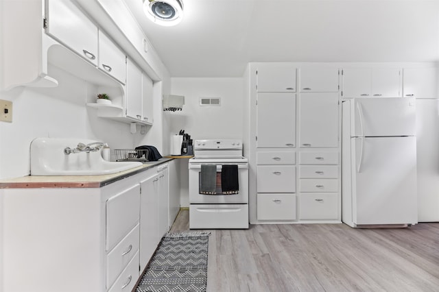 kitchen with white cabinetry, sink, white appliances, and light wood-type flooring