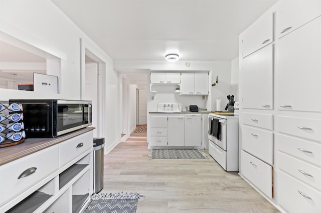 kitchen featuring white range with electric stovetop, white cabinetry, and light hardwood / wood-style floors