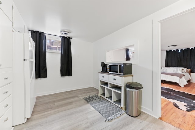 interior space featuring white fridge and light wood-type flooring