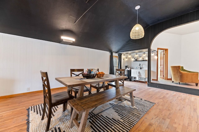 dining area featuring wood-type flooring and lofted ceiling