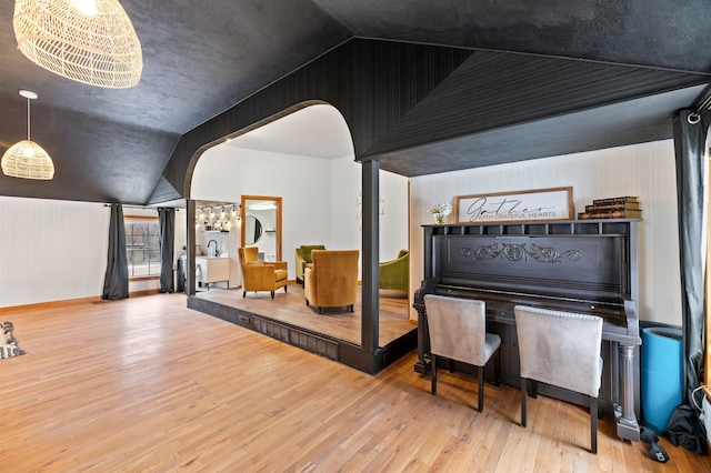 interior space featuring wood-type flooring and lofted ceiling