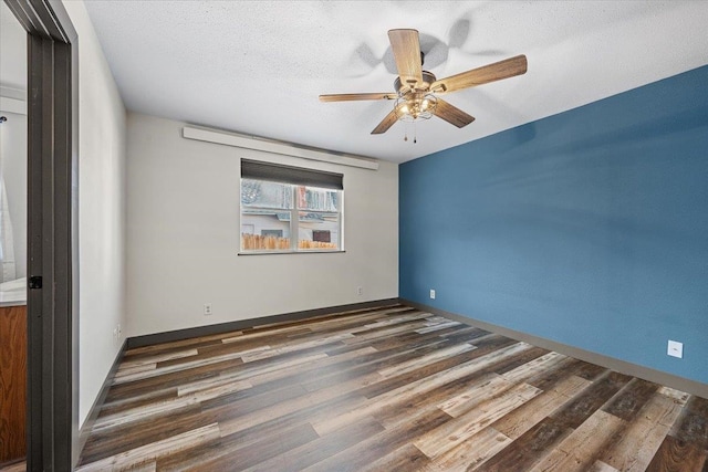 unfurnished bedroom featuring a textured ceiling, ceiling fan, and dark hardwood / wood-style floors