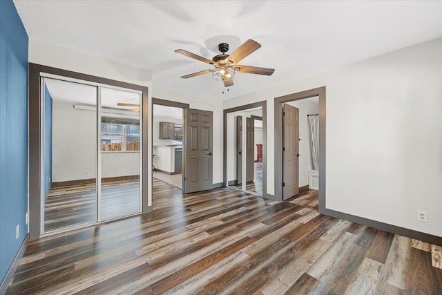 unfurnished bedroom featuring ceiling fan, dark hardwood / wood-style floors, and ensuite bathroom