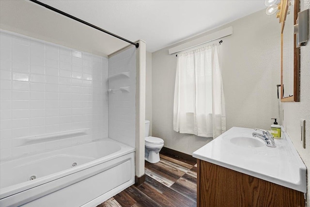 full bathroom featuring washtub / shower combination, vanity, wood-type flooring, and toilet