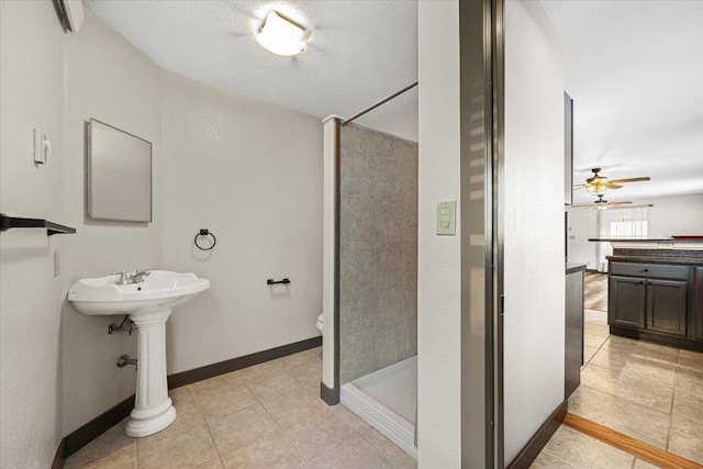 bathroom with a shower, tile patterned flooring, ceiling fan, toilet, and a textured ceiling