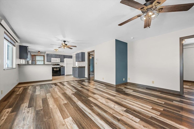 unfurnished living room with dark hardwood / wood-style floors