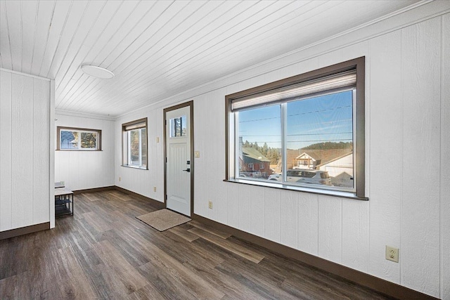 interior space featuring crown molding, wood ceiling, and dark wood-type flooring