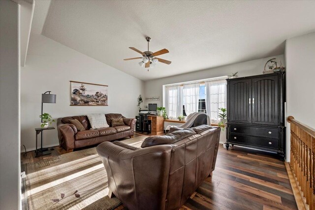 living room with dark hardwood / wood-style floors, ceiling fan, lofted ceiling, and a textured ceiling