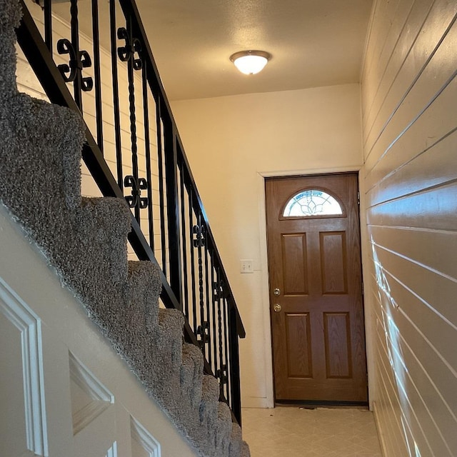 entryway with wooden walls