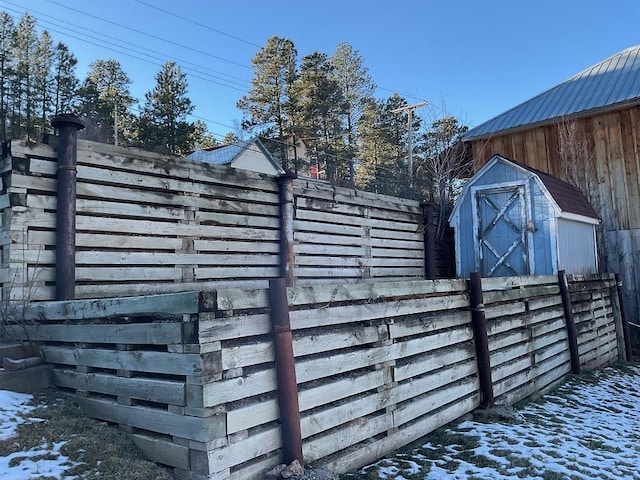 snow covered gate with a storage unit