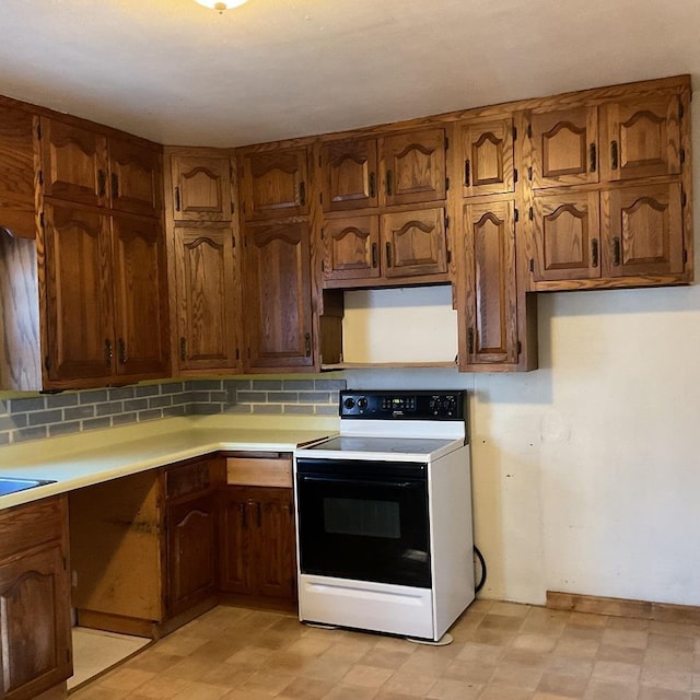 kitchen with tasteful backsplash and white range with electric stovetop