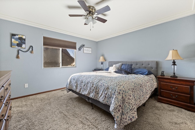 carpeted bedroom featuring ceiling fan and crown molding