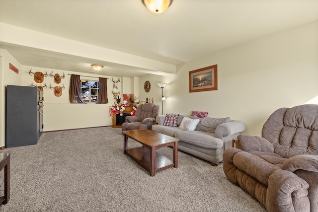 living room with beamed ceiling and carpet floors