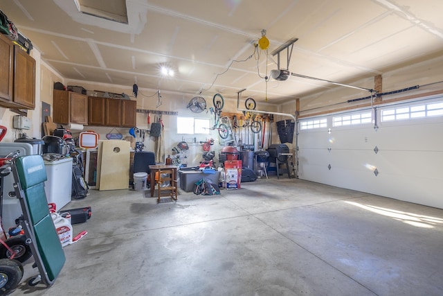 garage with a workshop area and a garage door opener