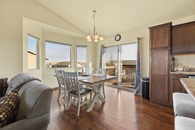 dining area featuring dark hardwood / wood-style flooring, vaulted ceiling, and a notable chandelier