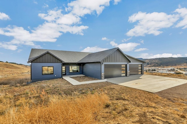 view of front facade featuring a mountain view and a garage