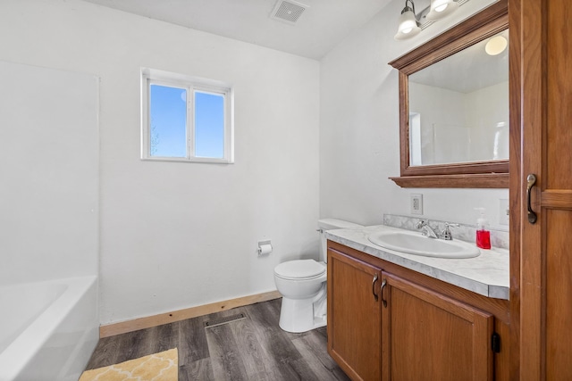 bathroom with hardwood / wood-style floors, vanity, and toilet